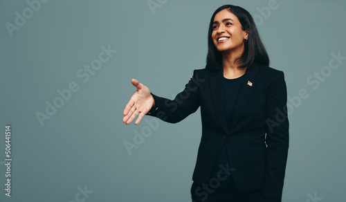 Friendly female politician holding out her hand for a handshake