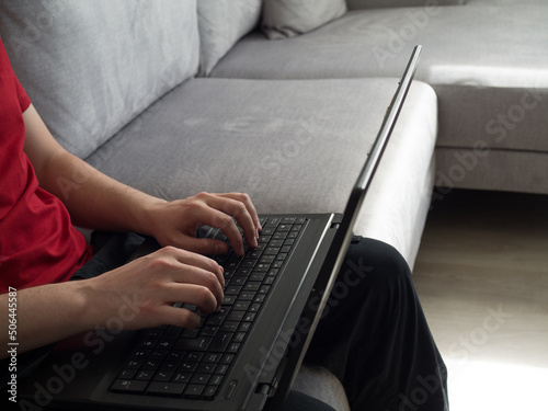 Man working from the sofa at home with the laptop