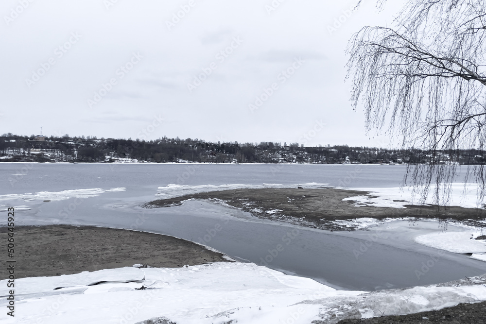 Frozen river, thawed places, beautiful landscape