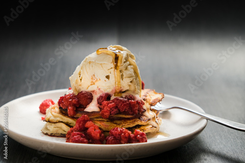 Close up of pancake stack with berries and ice cream. photo