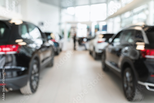 Vehicle purchase, rental, lease. Blurred view of automobile dealership store interior with new modern cars, copy space