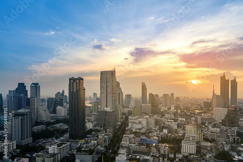 Cityscape of modern buildings and urban architecture. Aerial view of Bangkok city at twilight sunset in Thailand.