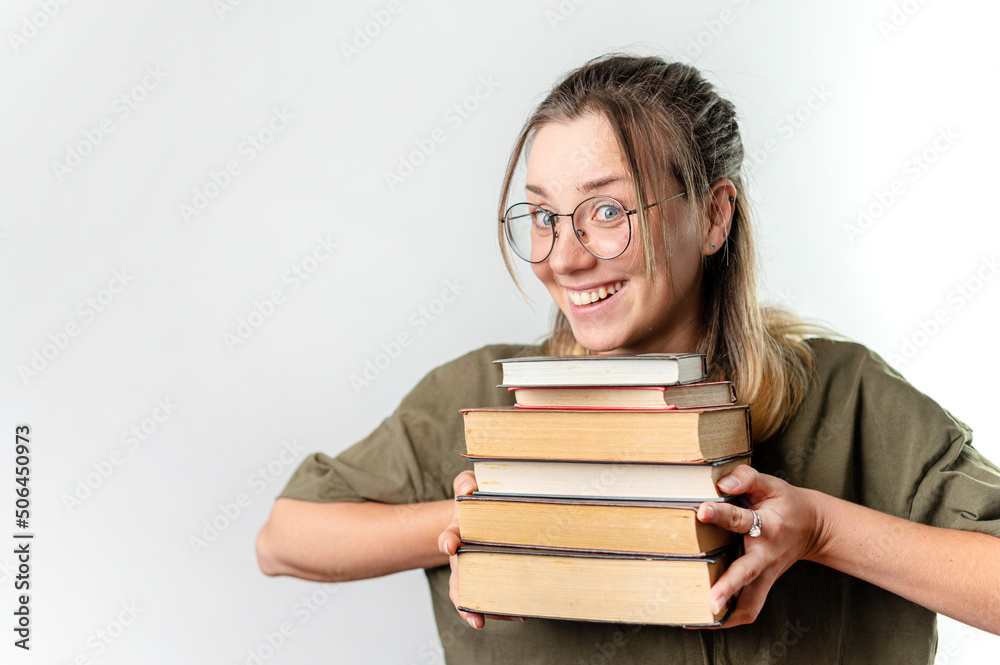 Young happy woman student holding books by her face on white background Young happy woman student holding books by her face on white background