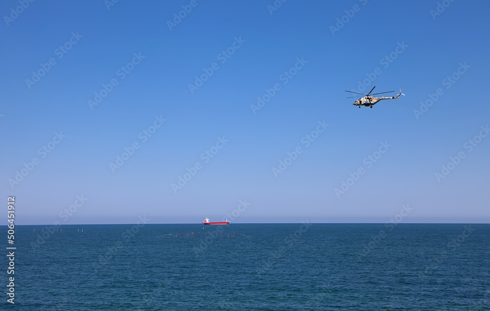 Russian helicopter flies over the sea