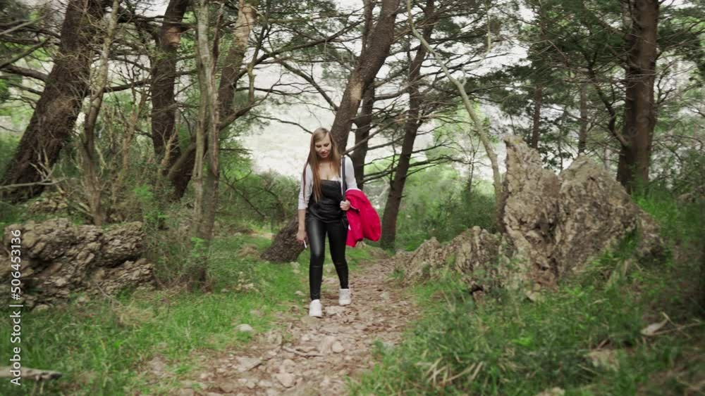A young girl walks in the mountains of Montenegro. Rise along the mountain path to the ruined fortress. Fortress in Sutomore Montenegro. Rest in the mountains of Montenegro. Hiking in the mountains. A young girl walks in the mountains of Montenegro. Rise along the mountain path to the ruined fortress. Fortress in Sutomore Montenegro. Rest in the mountains of Montenegro. Hiking in the mountains.