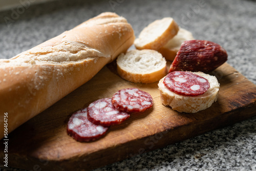 Sliced salami with bread as an appetizer before lunch