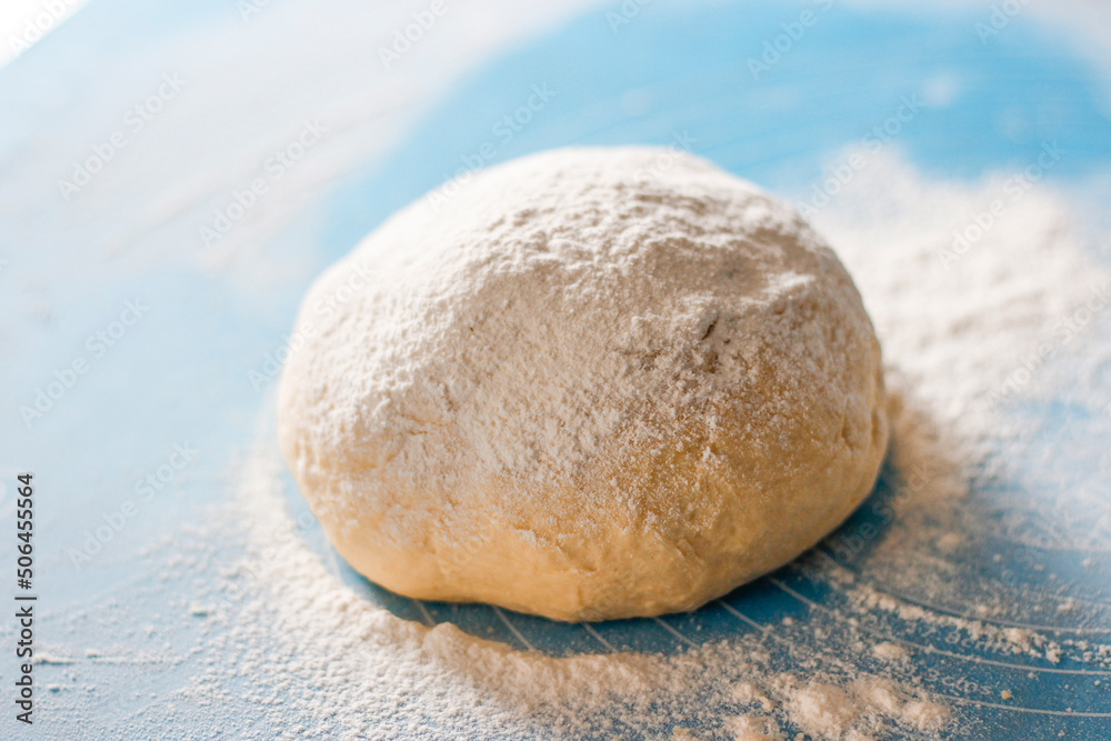 Rising or proofed yeast dough for bread or pizza on a floured surface Rising or proofed yeast dough for bread or pizza on a floured surface