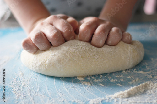 Woman's hands making dough for baking