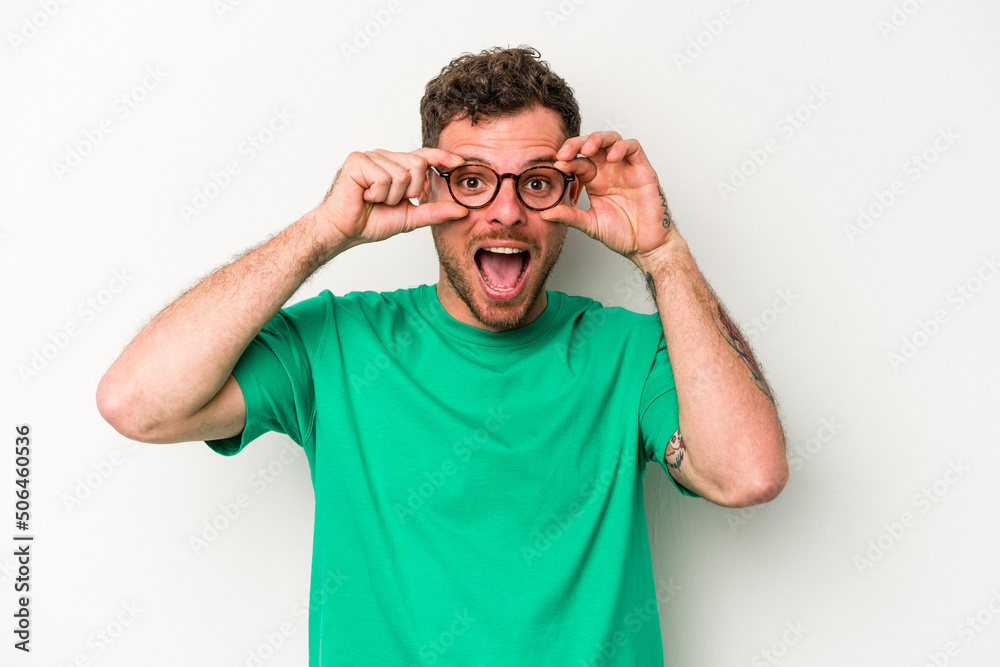 Young caucasian man isolated on white background keeping eyes opened to find a success opportunity. Young caucasian man isolated on white background keeping eyes opened to find a success opportunity.