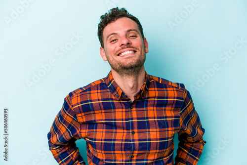 Young caucasian man isolated on blue background happy, smiling and cheerful.