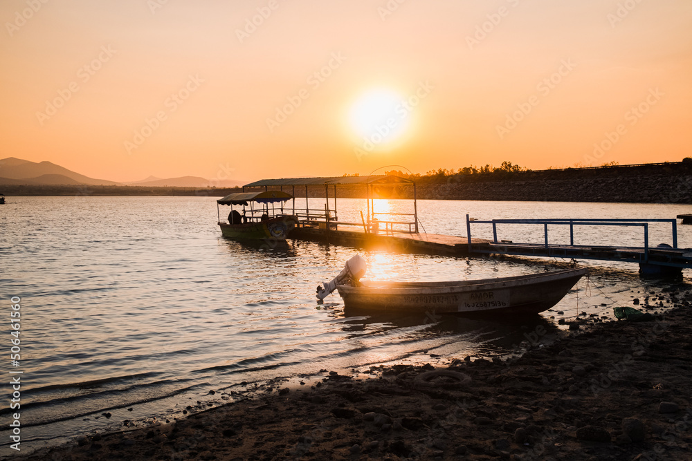 Boats docked at lake at sunset in Mexico