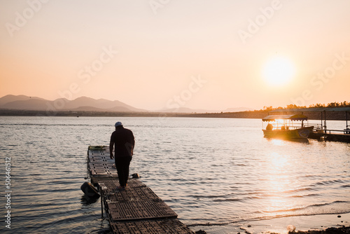 Man on dock lakeside sunset in Mexico