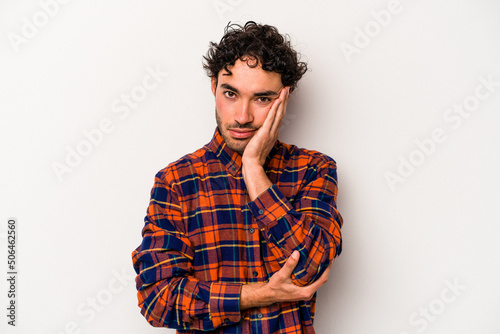 Young caucasian man isolated on white background who is bored, fatigued and need a relax day.