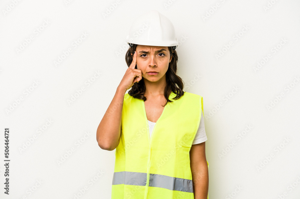 Young laborer hispanic woman isolated on white background pointing temple with finger, thinking, focused on a task. Young laborer hispanic woman isolated on white background pointing temple with finger, thinking, focused on a task.