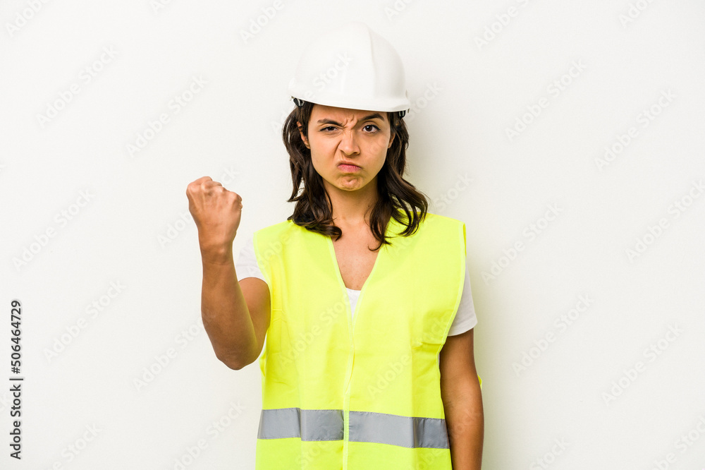 Young laborer hispanic woman isolated on white background showing fist to camera, aggressive facial expression. Young laborer hispanic woman isolated on white background showing fist to camera, aggressive facial expression.