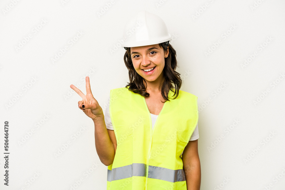 Young laborer hispanic woman isolated on white background joyful and carefree showing a peace symbol with fingers. Young laborer hispanic woman isolated on white background joyful and carefree showing a peace symbol with fingers.