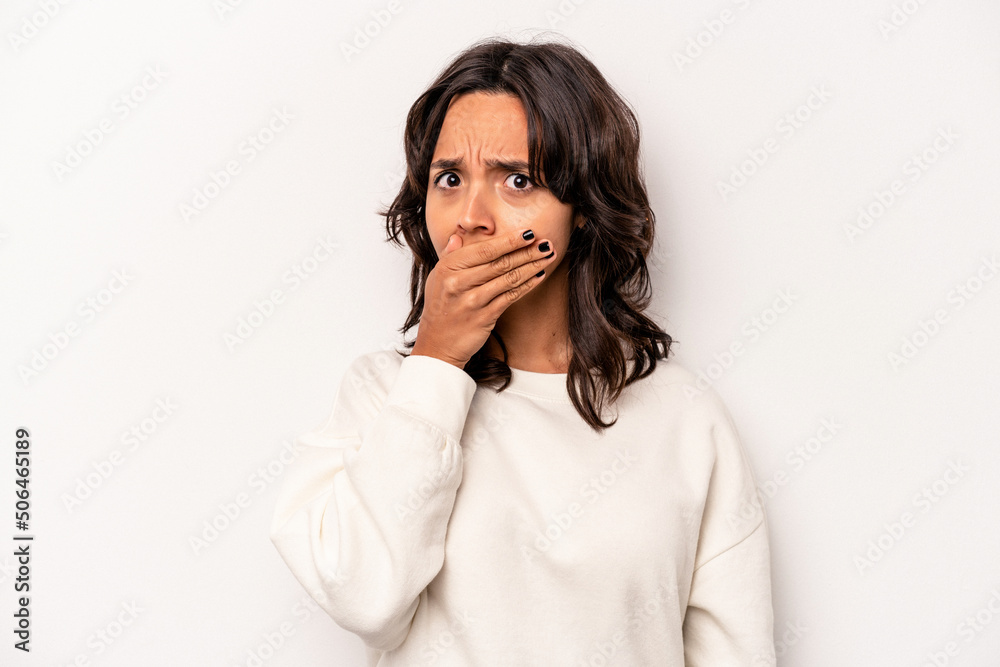 Young hispanic woman isolated on white background covering mouth with hands looking worried. Young hispanic woman isolated on white background covering mouth with hands looking worried.