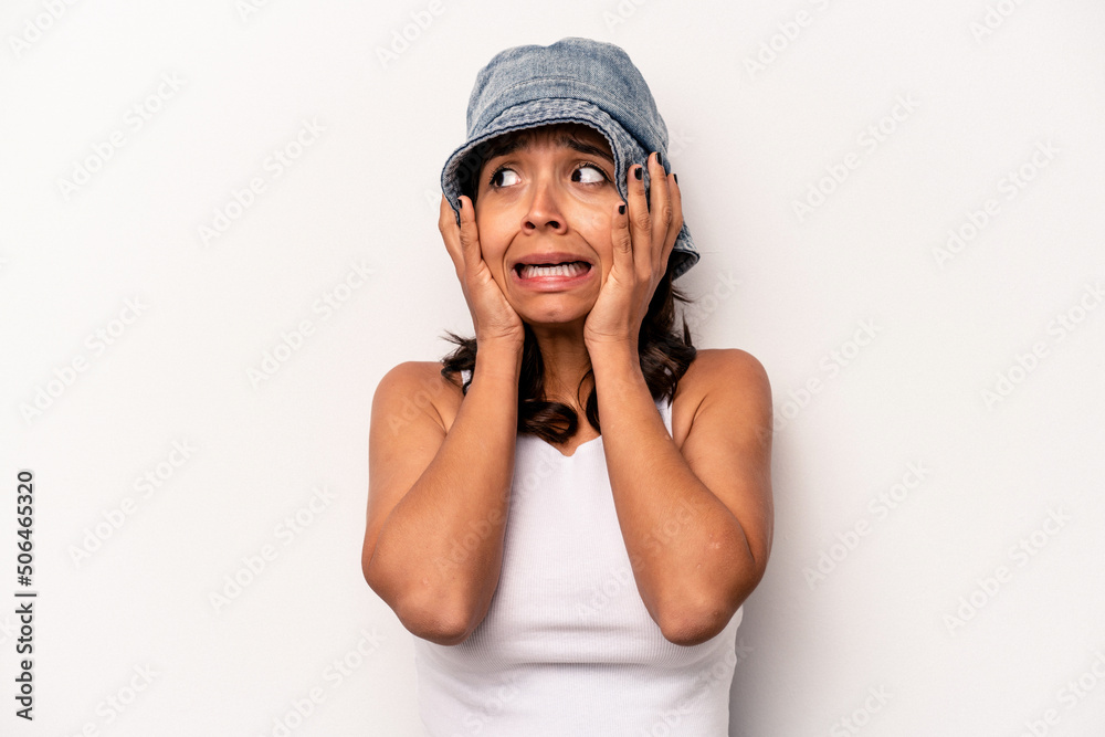 Young hispanic woman isolated on white background covering ears with hands trying not to hear too loud sound. Young hispanic woman isolated on white background covering ears with hands trying not to hear too loud sound.