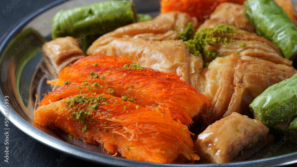 A tray of Turkish pastries including baklava, knafeh - a Middle Eastern cheese pastry soaked in sweet, sugar-based syrup A tray of Turkish pastries including baklava, knafeh - a Middle Eastern cheese pastry soaked in sweet, sugar-based syrup
