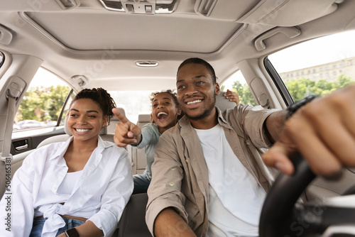 Excited Black Family Driving New Auto, Daughter Pointing Finger