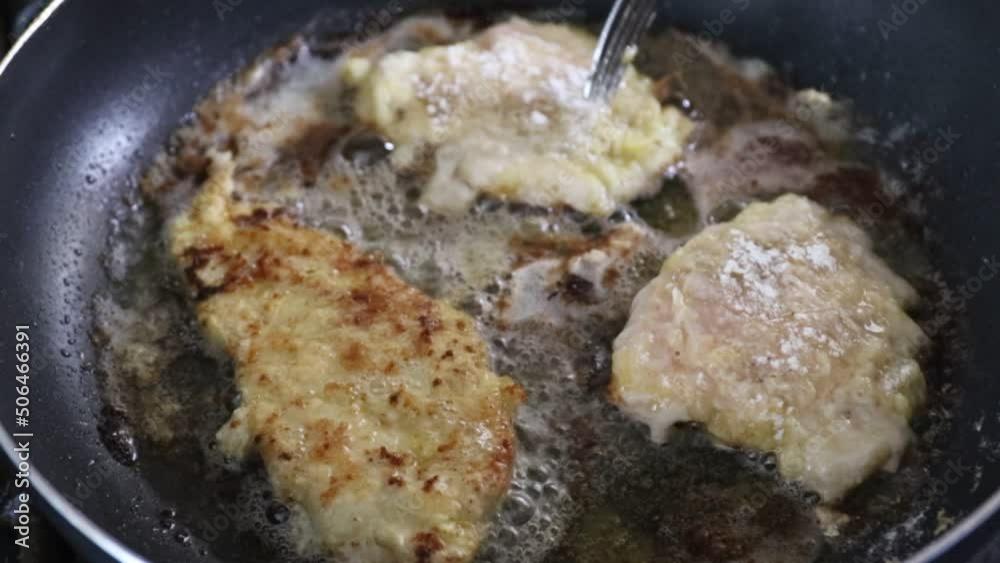 Chef frying chicken pieces in a Teflon-coated pan in a restaurant Chef frying chicken pieces in a Teflon-coated pan in a restaurant