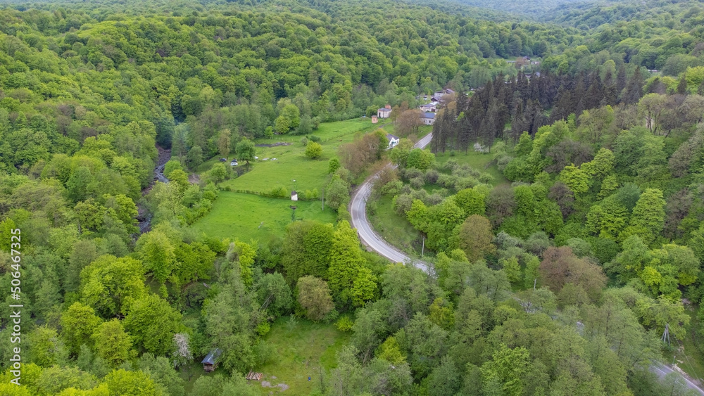 Shooting from a quadcopter. Top view, flat landscape. Forest, park, tree, hills, village, city, road
