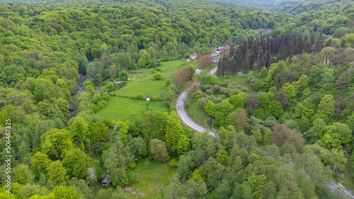 Shooting from a quadcopter. Top view, flat landscape. Forest, park, tree, hills, village, city, road