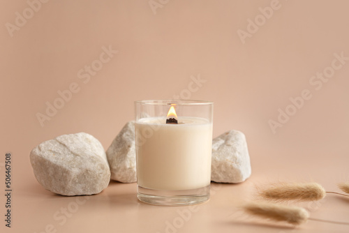 Obraz na plátně Vanilla burning candle on beige background