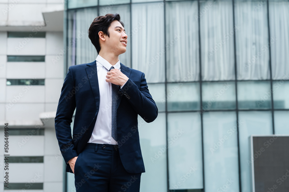 Image of Young asian businessman with glass building background Image of Young asian businessman with glass building background