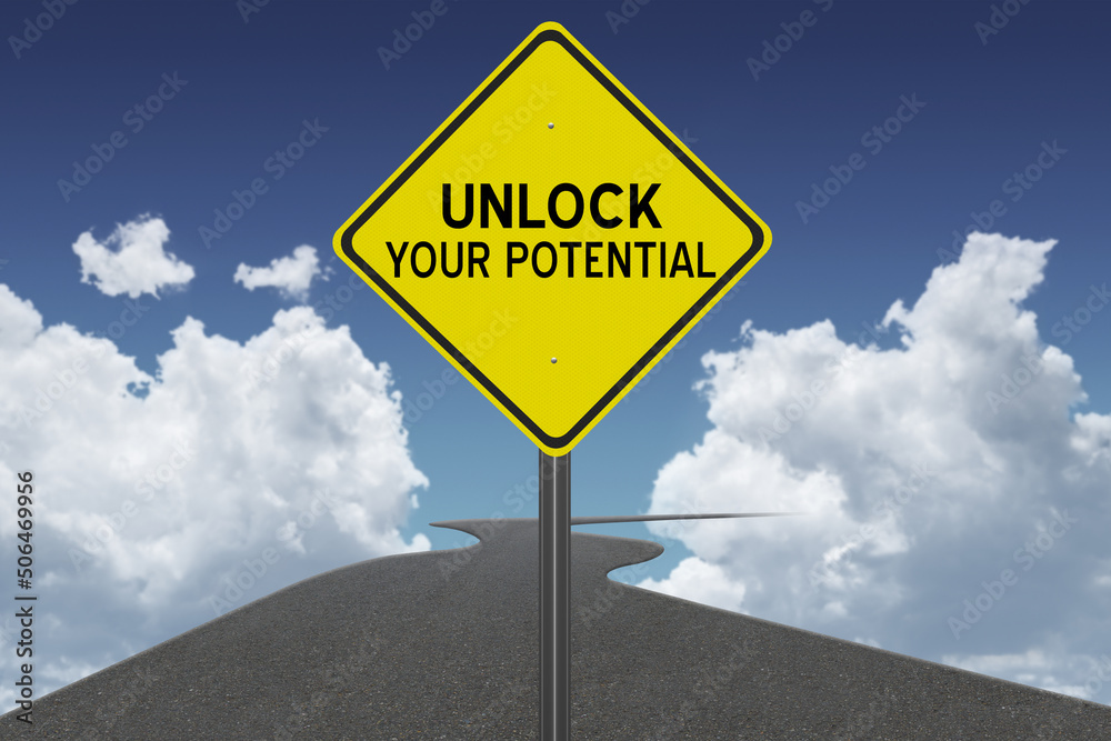Unlock Your Potential motivational quote on sign with road to success.