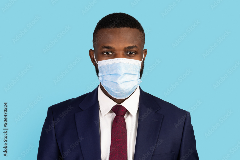 Portrait Of Black Businessman With Medical Mask On Face Looking At Camera Portrait Of Black Businessman With Medical Mask On Face Looking At Camera