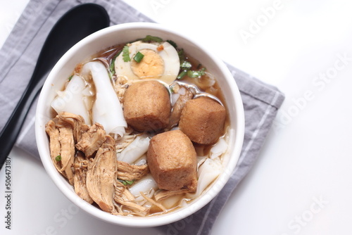 Thai food, Chinese roll noodle soup served in white cups on a white table.