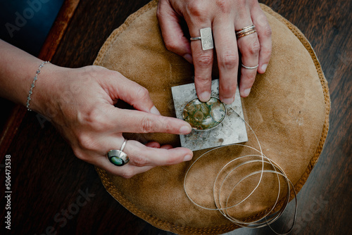 close up of metalsmith hands jeweler