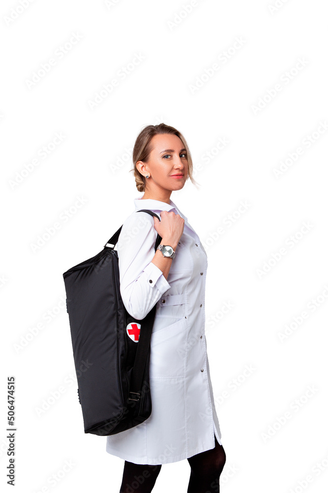 young female doctor in a medical gown holding a black bag and smiling.