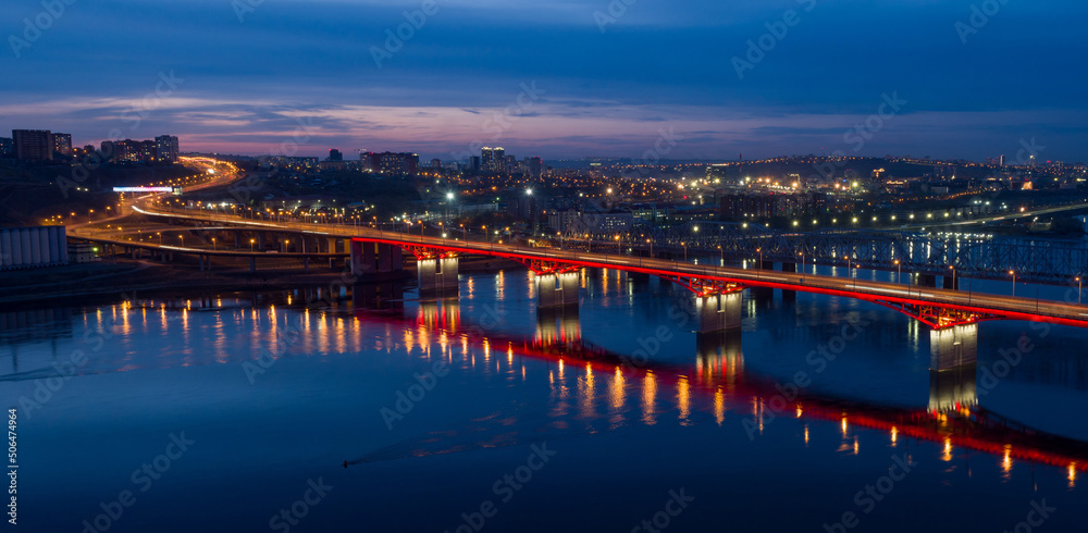 Panorama of the Siberian city of Krasnoyarsk. Night view from above on the Yenisei River and the Left Bank. New bridge