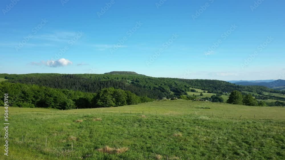 A lush green field and forest in the French countryside in Europe, France, Ardeche, in summer on a sunny day. A lush green field and forest in the French countryside in Europe, France, Ardeche, in summer on a sunny day.