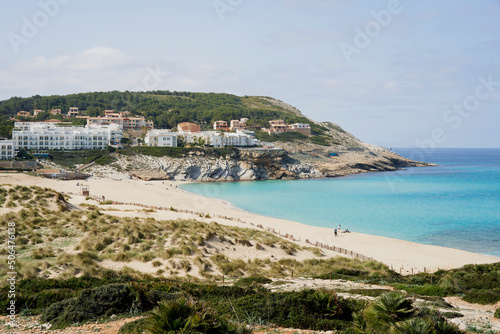 Cala Mesquida white sand beach with crystal clear waters between pine trees and dunes on the northeast coast of Majorca