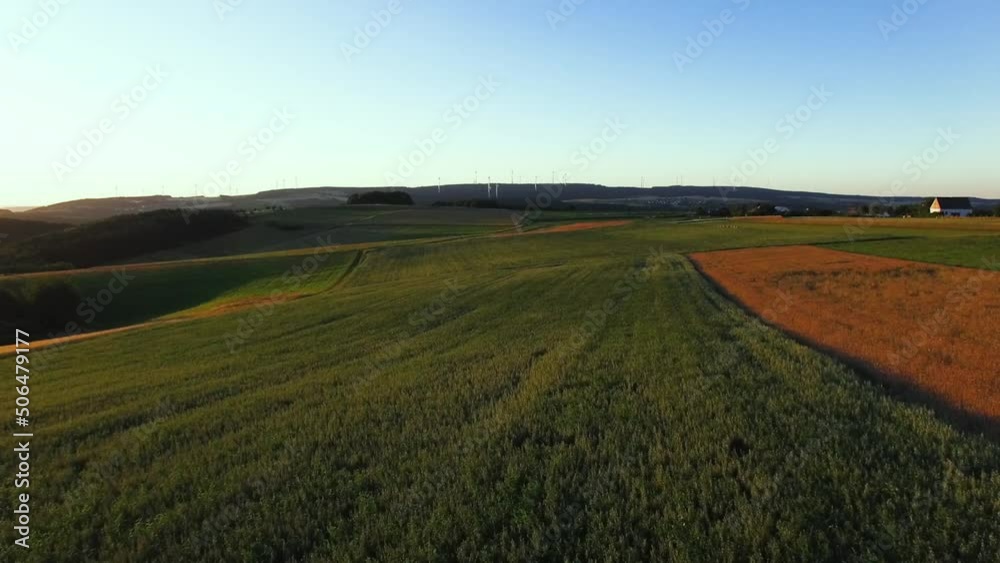 Flying over a field with a Drone. Wheat field and grass from the air with a drone shot Flying over a field with a Drone. Wheat field and grass from the air with a drone shot