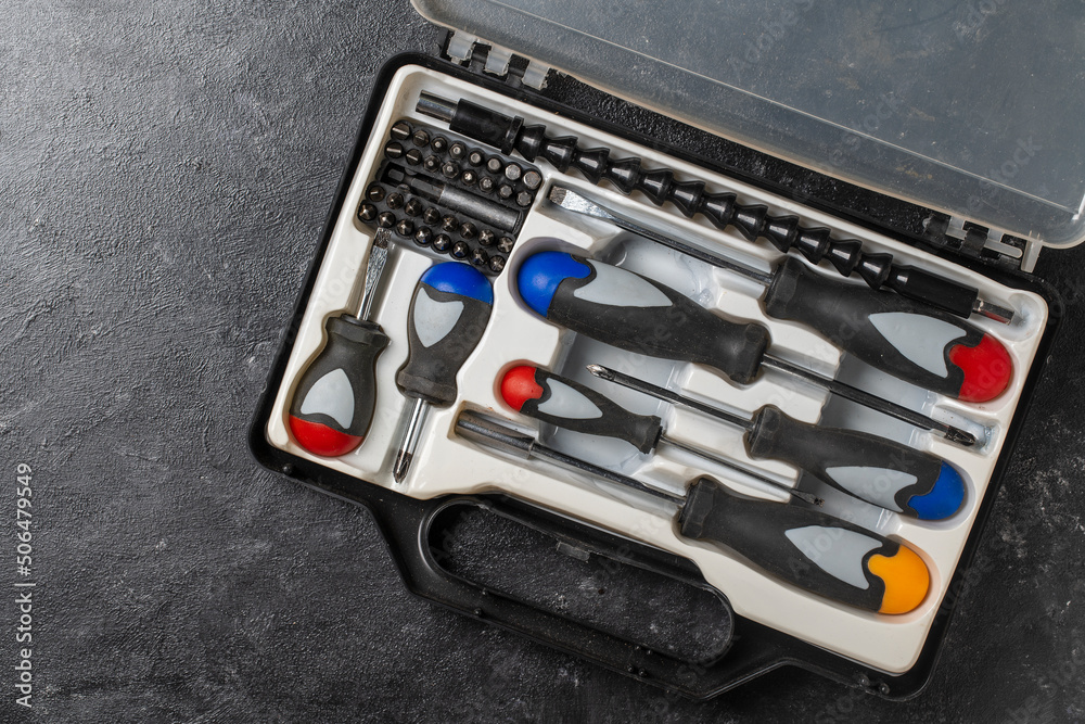 Fototapeta premium Set of screwdrivers inside toolbox, top view. Set mechanical tools in box