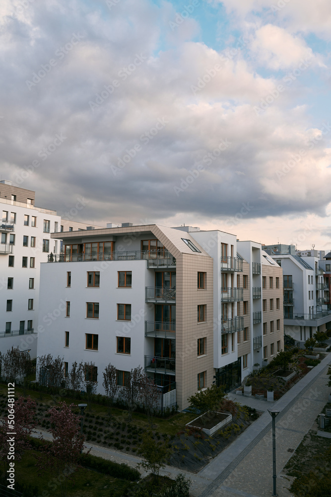 Exterior of a modern condominium. Residential area with ecological and sustainable green residential buildings, low-energy houses with apartments and green courtyard