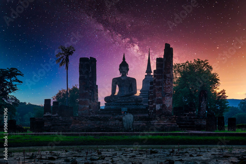 Fototapeta Milky way over Big Buddha at night in Wat Mahathat temple, Sukhothai Historical Park, Thailand