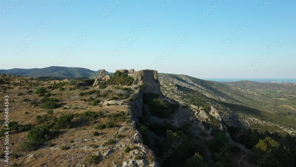 The castle of Opoul Perillos on the cliff side above the village in Europe, France, Occitanie, the Pyrenees Orientales, in summer, on a sunny day. The castle of Opoul Perillos on the cliff side above the village in Europe, France, Occitanie, the Pyrenees Orientales, in summer, on a sunny day.