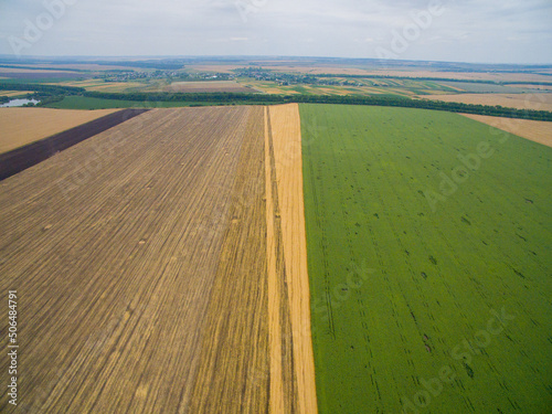 Harvesting in the field. Aerial view. A Lot of Land