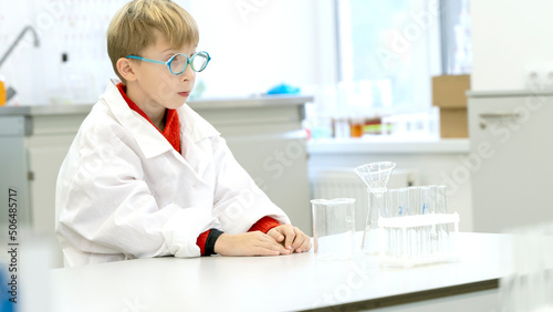 a student in a chemical laboratory conducts chemical sweats with chemical elements