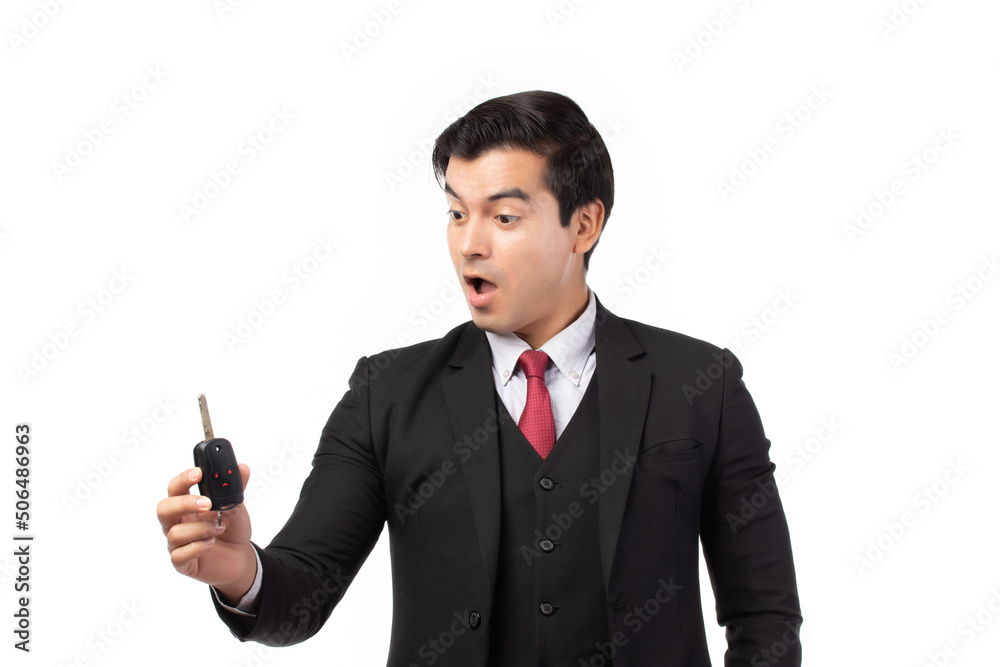 Portrait of a confident business man in black suit feeling happy and smile holding the keys of the car isolated on white background. Portrait of a confident business man in black suit feeling happy and smile holding the keys of the car isolated on white background.