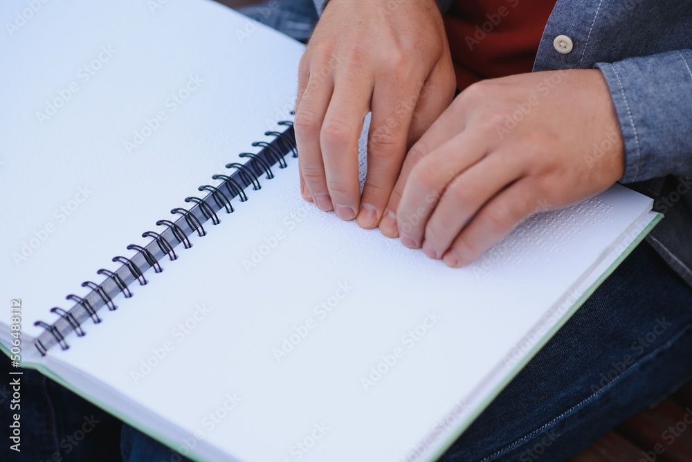 Blinded man reading by touching braille book Blinded man reading by touching braille book