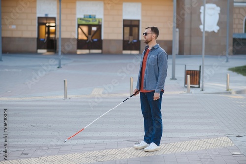 Blind man. People with disability, handicapped person and everyday life. Visually impaired man with walking stick.