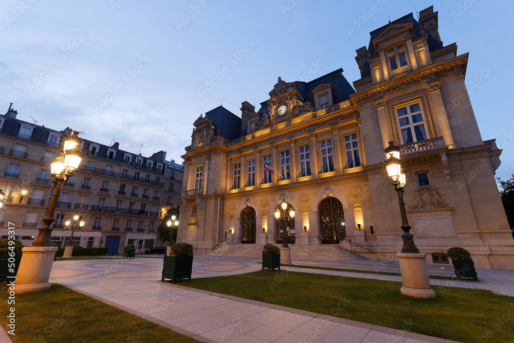 The facade of Neuilly-sur-Seine town hall at night . A suburb of Paris, Neuilly is immediately adjacent to the city and directly extends it.