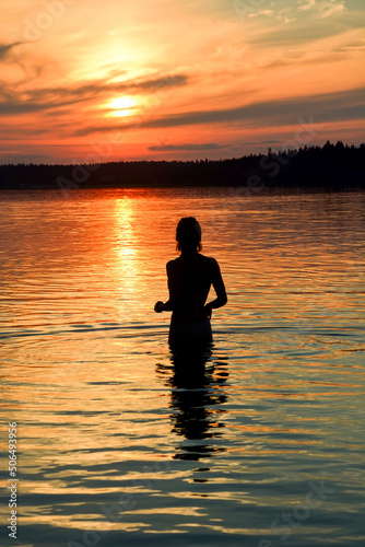 Young woman silhouette at Krasavitsa lake, Zelenogorsk, Russia