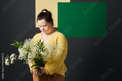 Print op canvas Studio portrait of modern young woman with Down syndrome wearing stylish casual